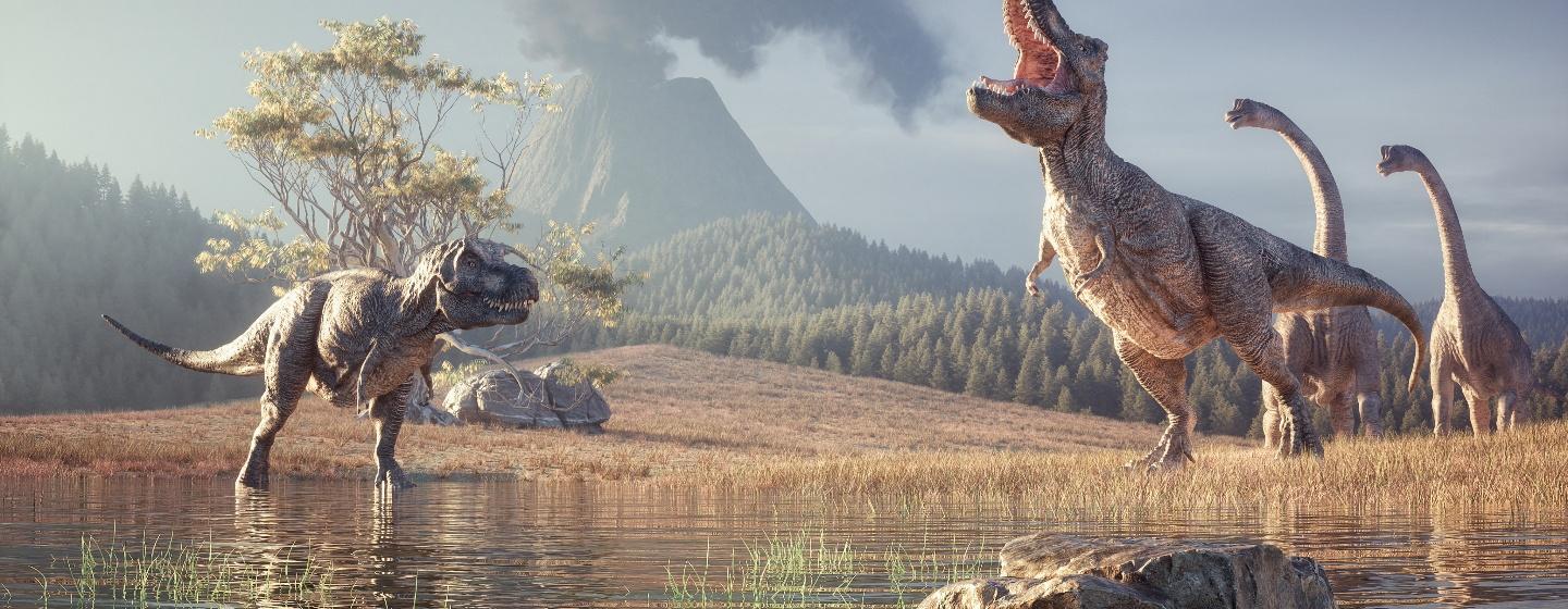 Dinosaurs are roaming with a volcano in the background