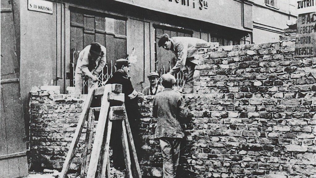 Photo of workers building a brick wall to block off the Jewish ghetto portion of Warsaw, Poland in 1940.